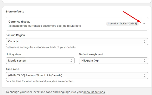Shopify Admin Store defaults section with the Currency display menu